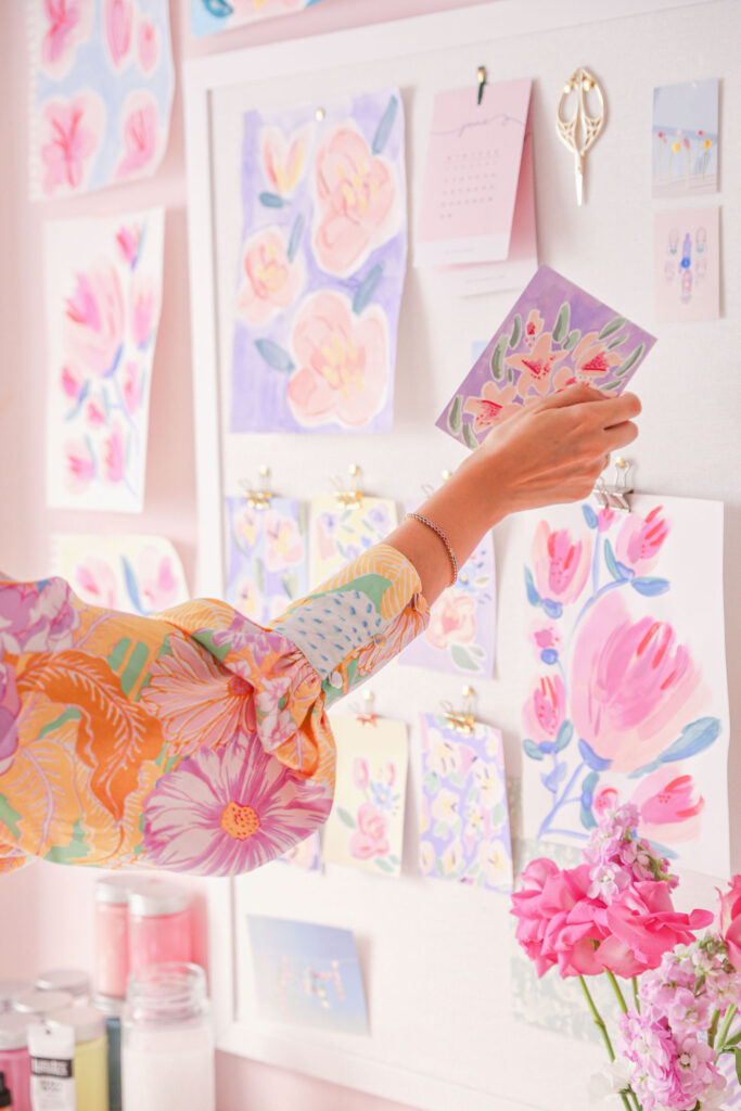 maria marie in a flower patterned blouse surrounded by pastel floral art